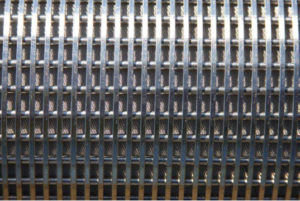 Stainless steel horizontal well screen with exterior wire mesh jacketing.