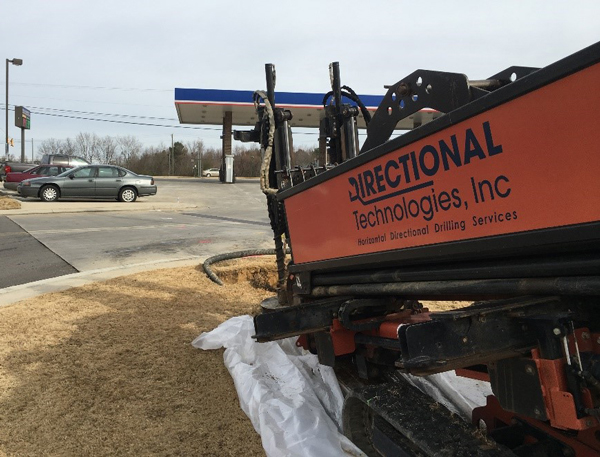 Directional drill rig setup within the corner of the site, drilling towards the target treatment area.