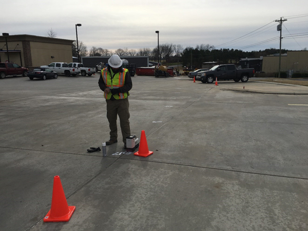 Walk-over locating of the directional drill bit (drill rig in the far background, 170 feet away).